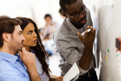 Image of consultant working with two employees