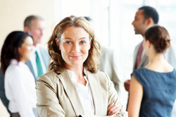 Image of female manager with staff in background